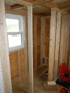 Bathroom - Shower on right and compost toilet bottom left to side of window. 